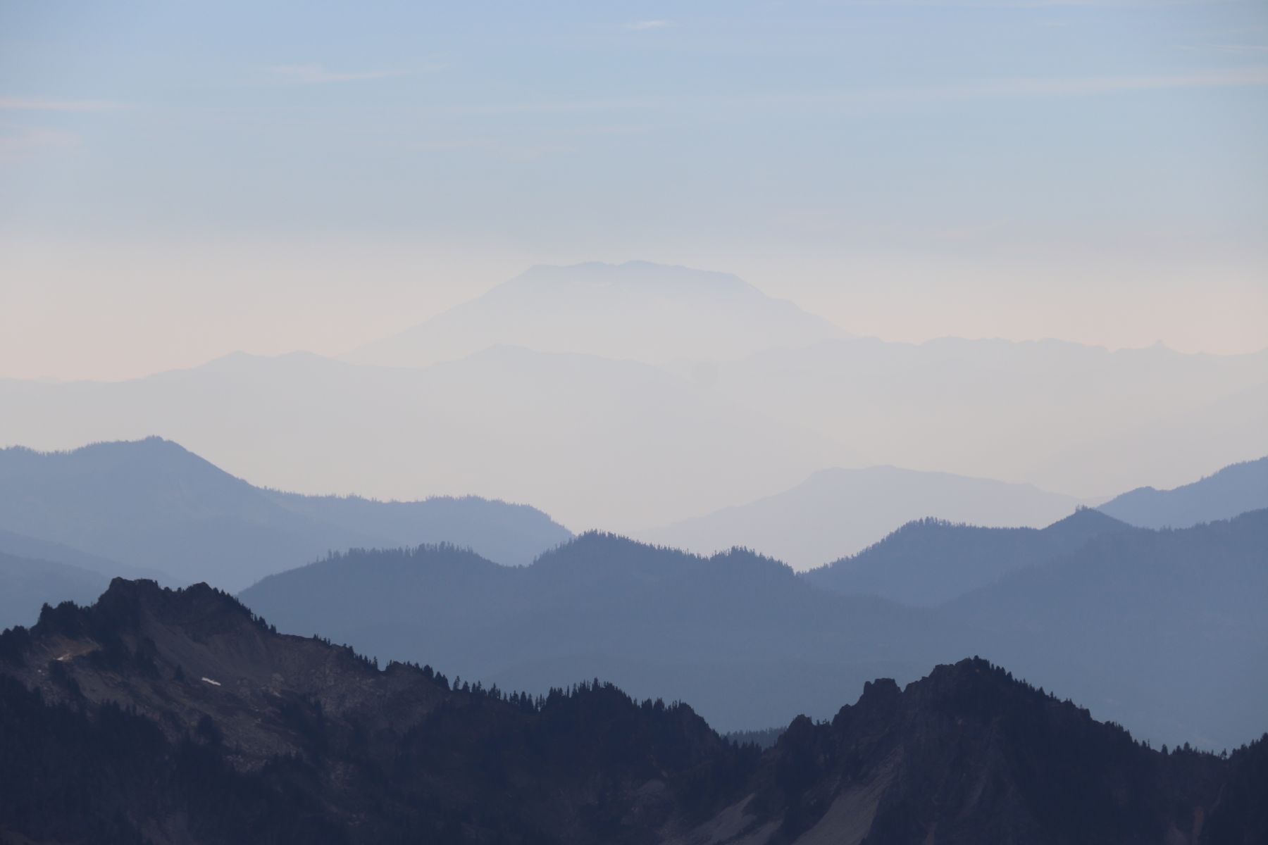 Layered blue mountain ridges fading into haze